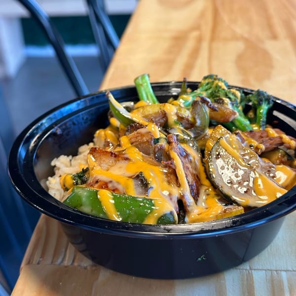 Itokos Grill's Japanese bowl with rice, meat, vegetables, and a creamy orange sauce.